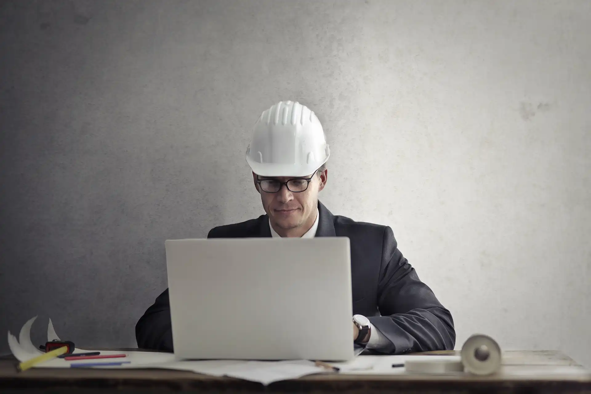 General contractor project manager reviewing digital plans and schedules on site