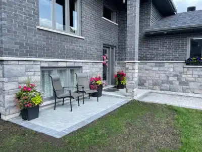 Commercial landscaping crew completing hardscape and patio installation work